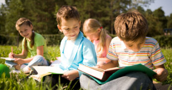 kids reading in the nature